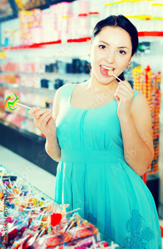 Woman posing to photographer with lollypop