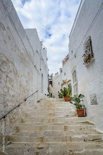 Fototapeta Naklejka Na Ścianę i Meble -  Alleyway with stairs in Ostuni, Puglia, Italy