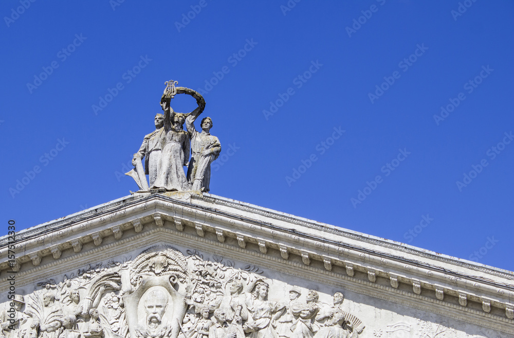 Old Statues On The Roof Of The Theatre With Blue Sky
