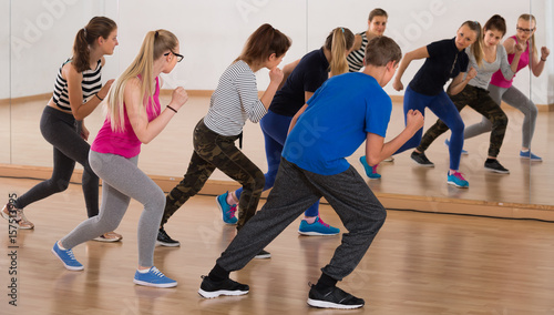 teenage boys and girls learning in dance hall