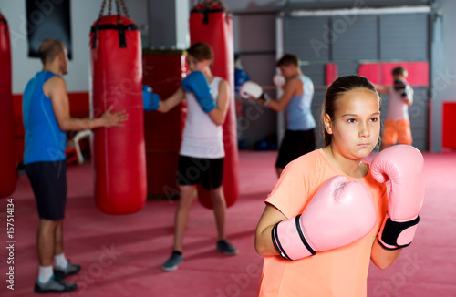 Girl with boxing gloves posing in defended stance © JackF
