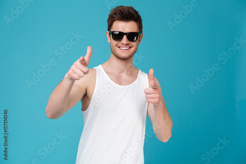 Smiling man pointing at camera isolated