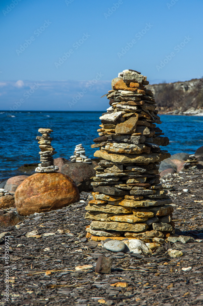 Pyramid of stones on the beach in sunny day Pyramid of stones on the beach in sunny day