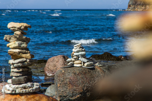 Pyramid of stones on the beach in sunny day