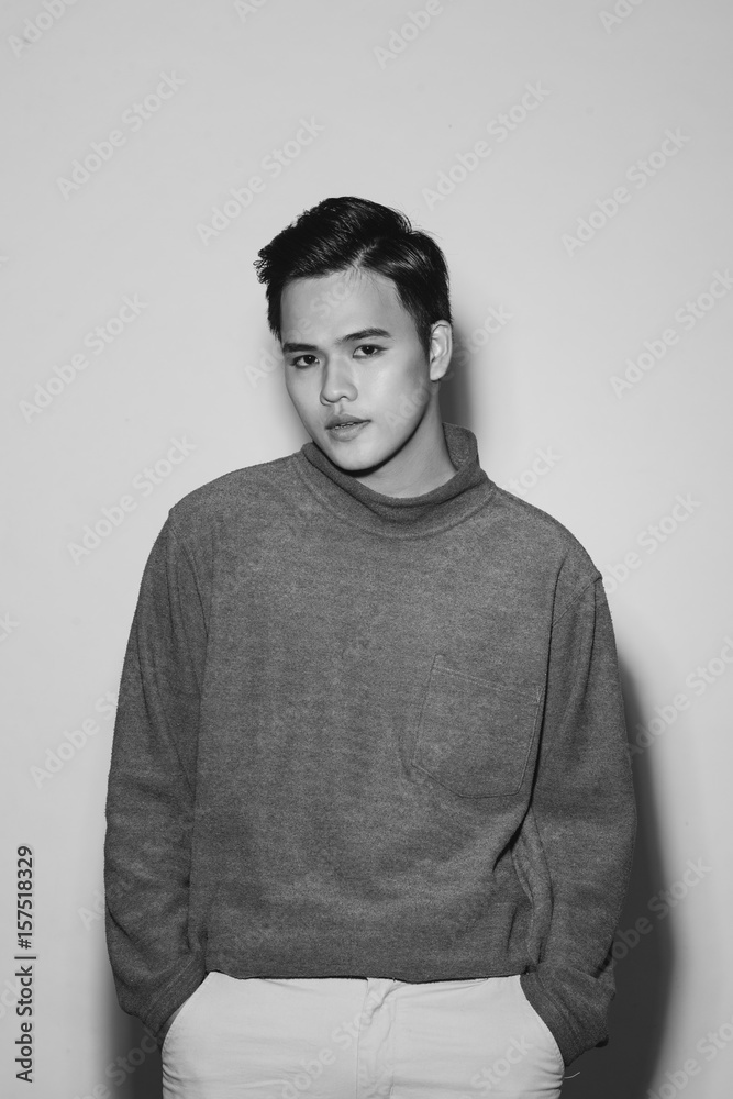 Fototapeta premium Young asian man's portrait against black background