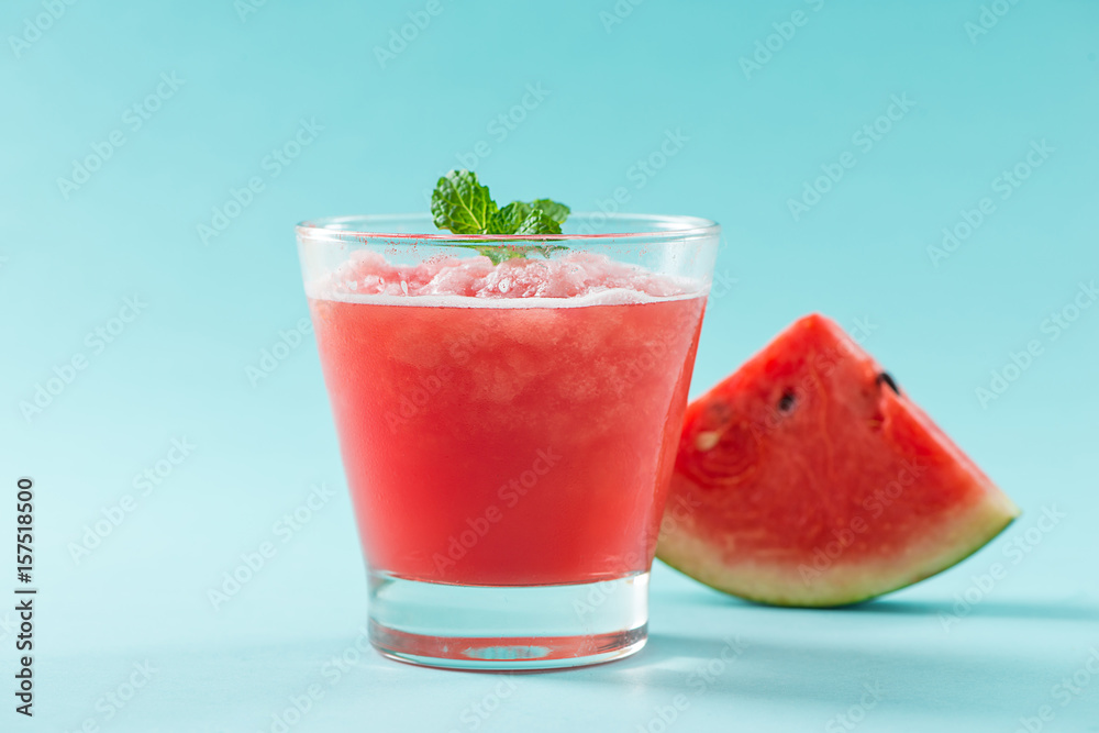 Glass of healthy watermelon juice in summertime on blue background. Glass of healthy watermelon juice in summertime on blue background.