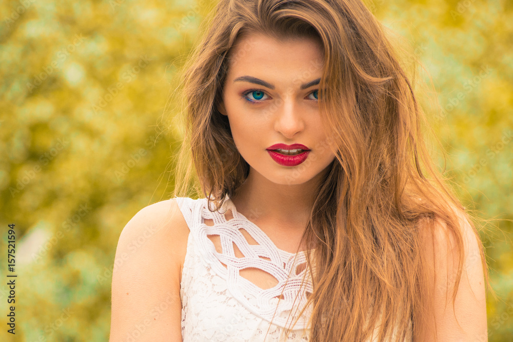 Fototapeta premium young beautiful model in white dress in the summer garden