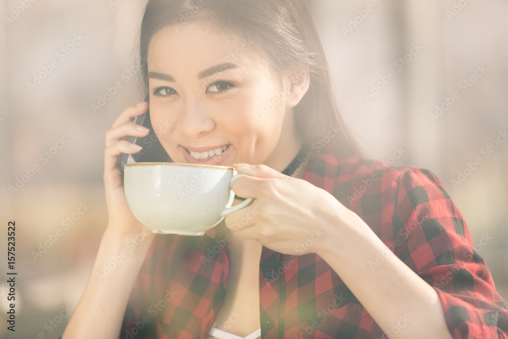 attractive asian girl using smartphone and drinking coffee in cafe, coffee break concept attractive asian girl using smartphone and drinking coffee in cafe, coffee break concept