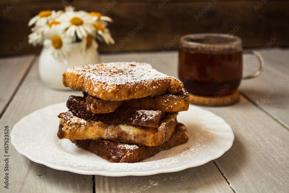 french toast with tea on wooden background
