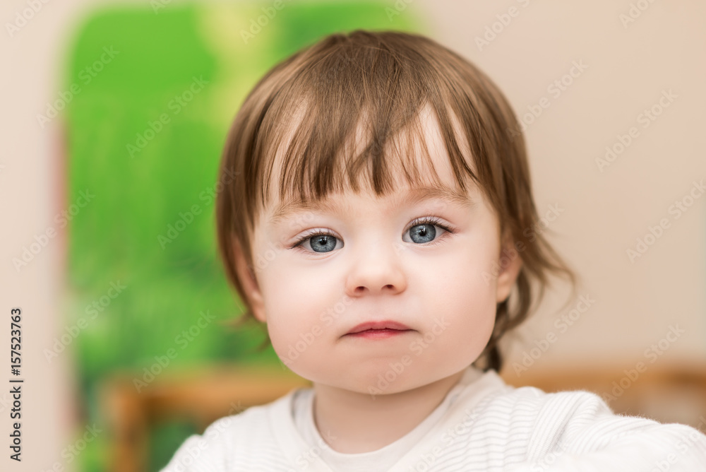 portrait of adorable baby girl with blue eyes, indoors