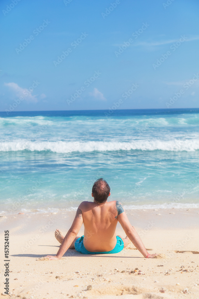Man enjoying on empty tropical exotic beach.