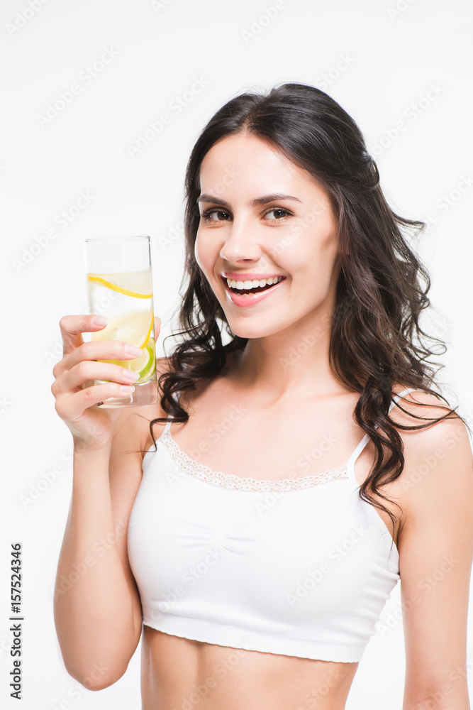 portrait of smiling woman holding glass of water in hand isolated on white portrait of smiling woman holding glass of water in hand isolated on white