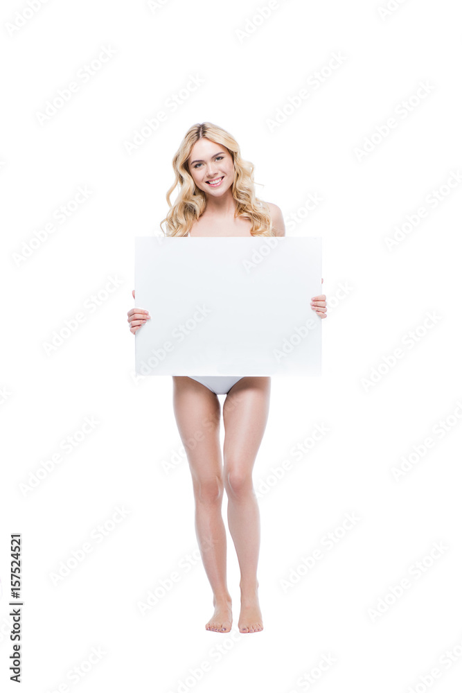 Smiling young blonde woman in lingerie holding blank card and looking at camera Smiling young blonde woman in lingerie holding blank card and looking at camera