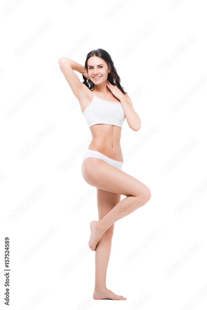 Beautiful smiling young woman posing in white underwear and looking at camera