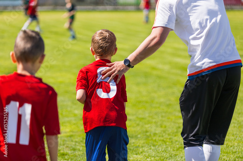 Youth Soccer Substitution. Junior Soccer Football Team Change. Coach Motivating Young Soccer Player. Coaching Children School Soccer Team