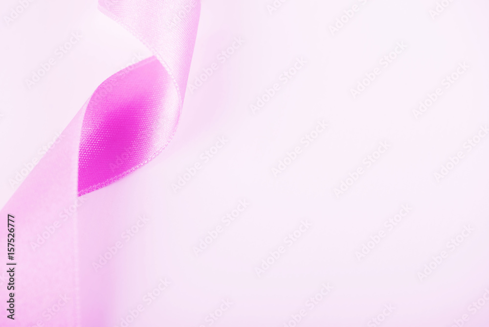 Pink ribbon on white background. Background. Copy space.