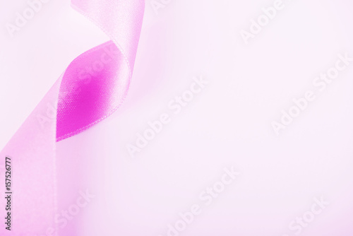 Pink ribbon on white background. Background. Copy space.