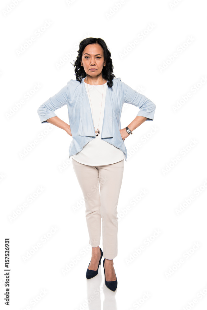 serious asian woman standing with hands on waist isolated on white serious asian woman standing with hands on waist isolated on white