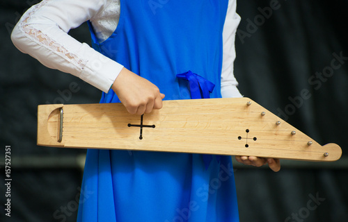 Girl with kannel performing on stage. photo