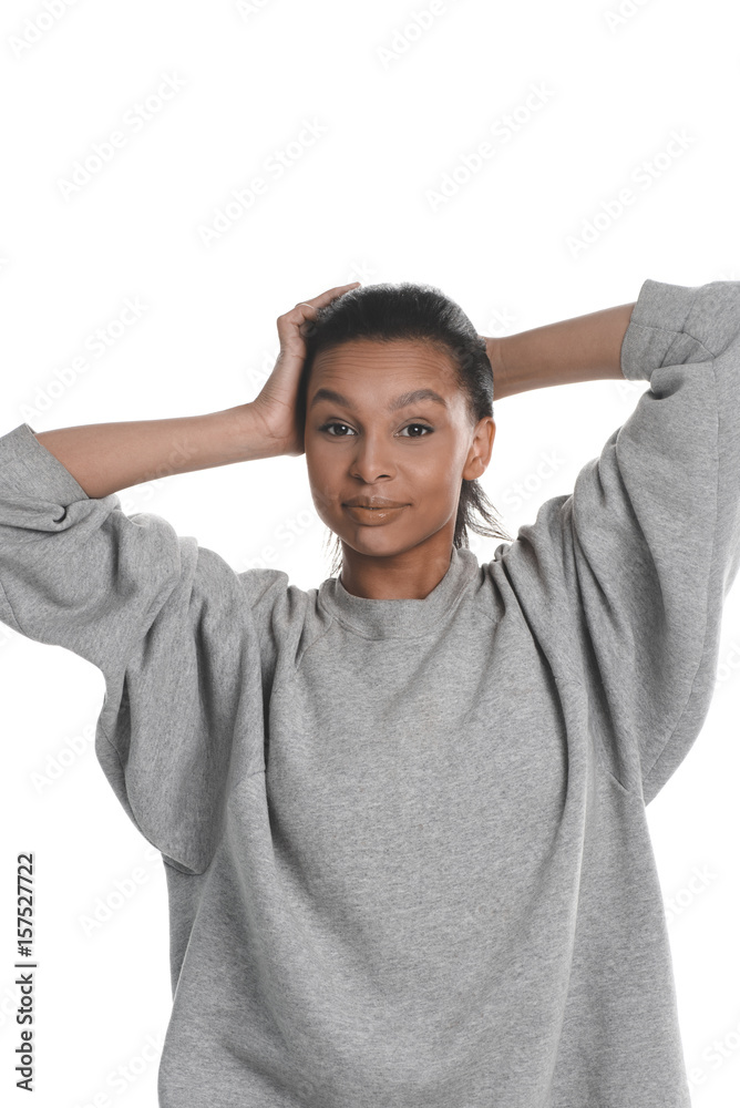 Smiling young african american woman posing in grey sweater isolated on white Smiling young african american woman posing in grey sweater isolated on white
