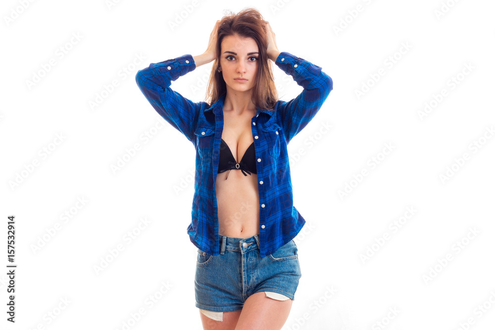 young slender sexy girl stands in front of the camera with the unbuttoned shirt and keeps hands hair young slender sexy girl stands in front of the camera with the unbuttoned shirt and keeps hands hair