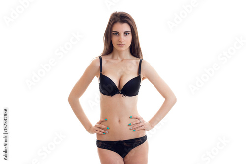 beautiful young girl in black lingerie with sexy body keeps your hands on the sides and looks into a camera © ponomarencko