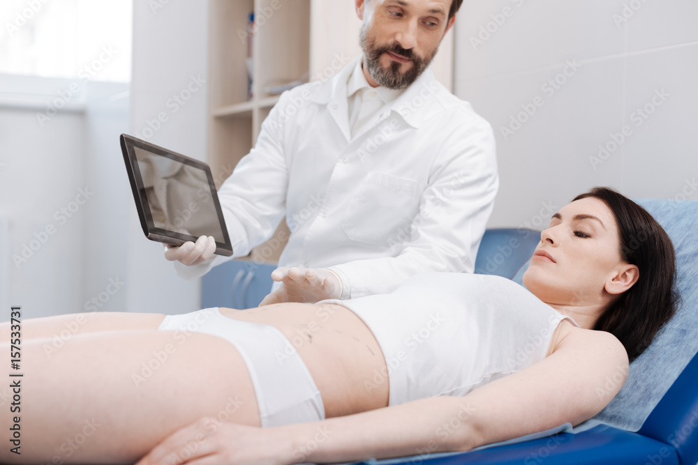 Professional plastic surgeon having his work explained Professional plastic surgeon having his work explained