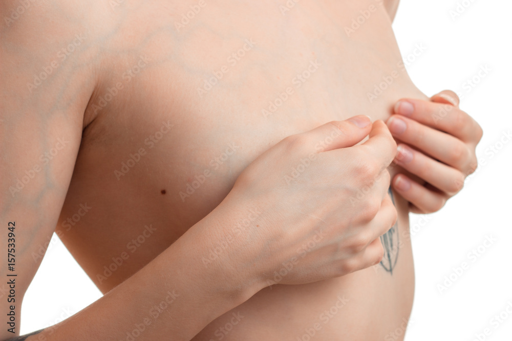 young girl holding hands her bare chest close-up Stock Photo