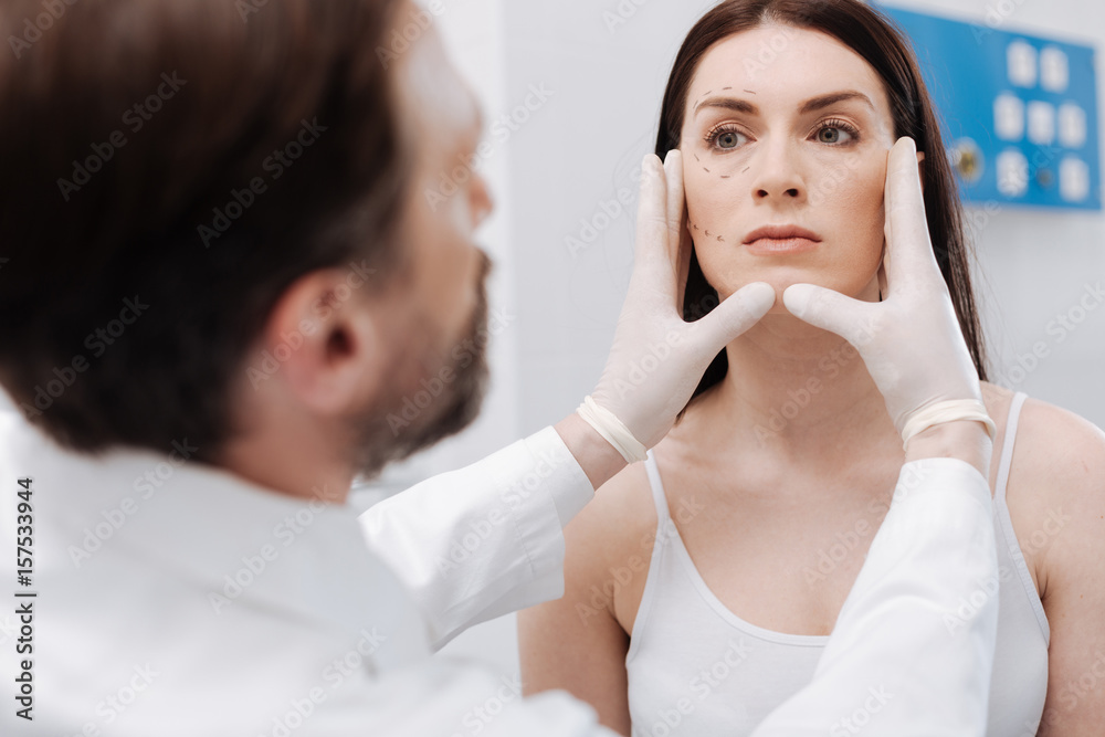 Professional plastic surgeon defining the volume of work