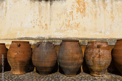 Huge old ceramic pots in a monastery in Chania region on Crete island, Greece.