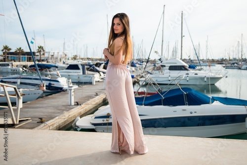 Beautiful young girl in a port