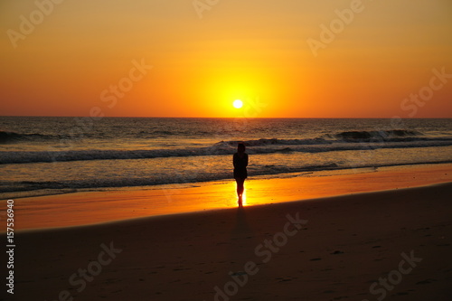 silhouette of beautiful woman at sea sunset