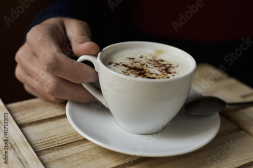 young man with a cup of cappuccino