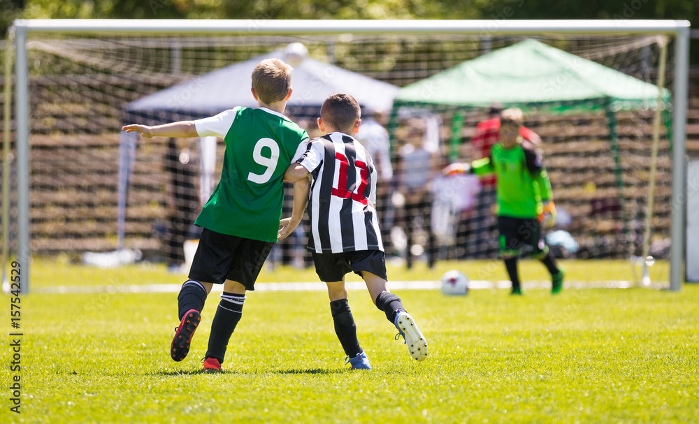 Obraz premium Running Youth Soccer Football Players. Boys Kicking Soccer Match. Children Football Players Running After the Ball. Kids Sport Duel