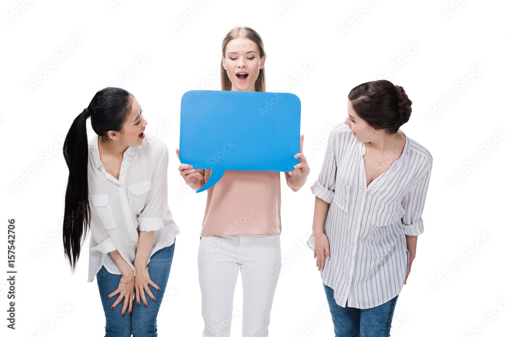 young casual girls holding blank speech bubble isolated on white young casual girls holding blank speech bubble isolated on white