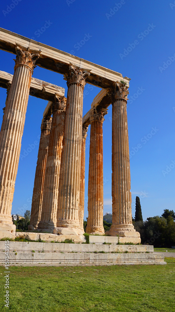 Photo of iconic pillars of Temple of Olympian Zeus with view to the Acropolis and the Parthenon, Athens historic center, Attica, Greece 