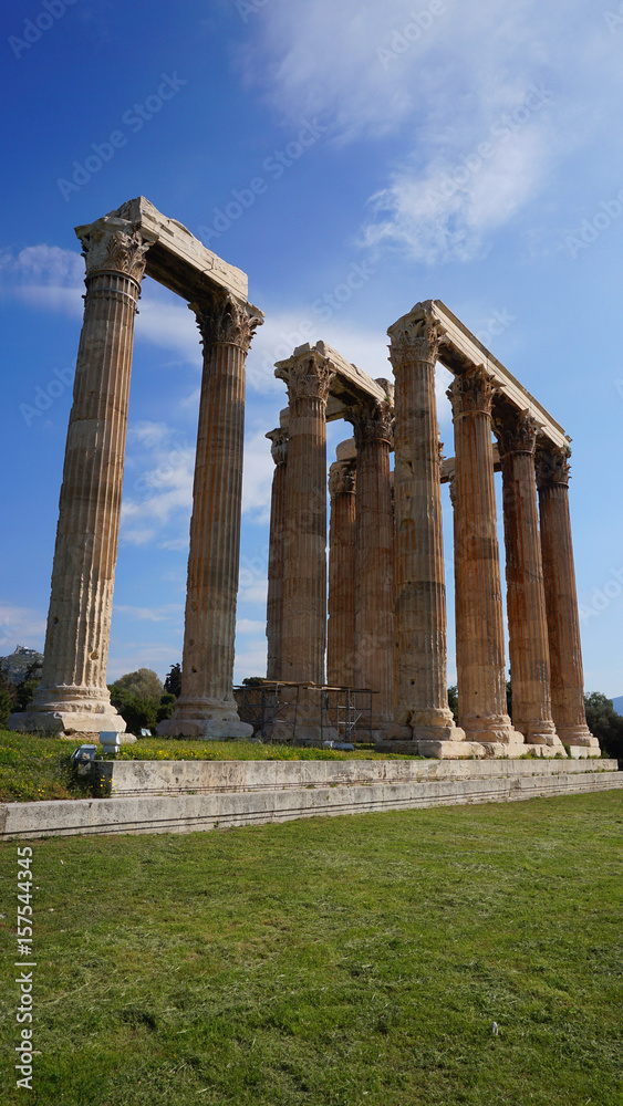 Photo of iconic pillars of Temple of Olympian Zeus with view to the Acropolis and the Parthenon, Athens historic center, Attica, Greece 