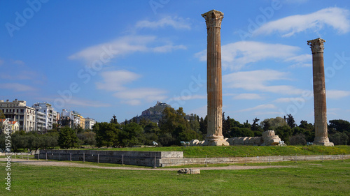 Photo of iconic pillars of Temple of Olympian Zeus with view to the Acropolis and the Parthenon, Athens historic center, Attica, Greece 