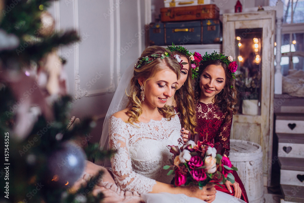 Bright photo of the bride and bridesmaids in red dress in the room Bright photo of the bride and bridesmaids in red dress in the room