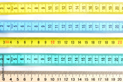Rulers of different materials lying in parallel