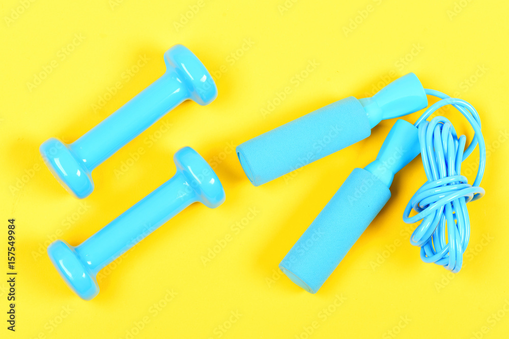 dumbbells and skipping rope, sport, healthy lifestyle and objects concept dumbbells and skipping rope, sport, healthy lifestyle and objects concept