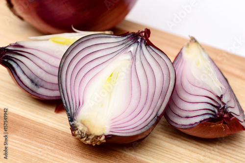 Half and quarters of red onion with whole purple vegetable