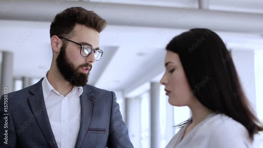 Young businessman talking to his colleague about something Young businessman talking to his colleague about something