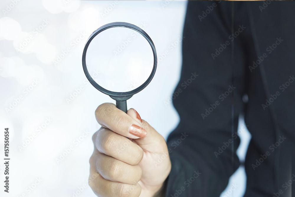 business woman or human resource standing in black suit with magnifier glass in hand with copy space business woman or human resource standing in black suit with magnifier glass in hand with copy space