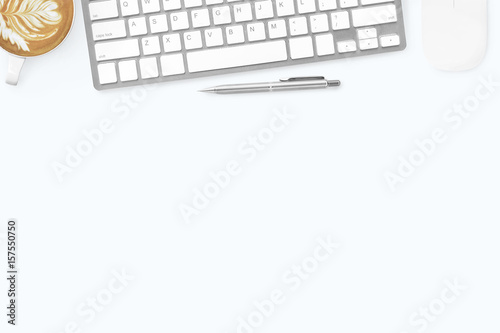 White minimal office desk table with computer keyboard, mouse, latte coffee and pen. Top view with copy space, flat lay.