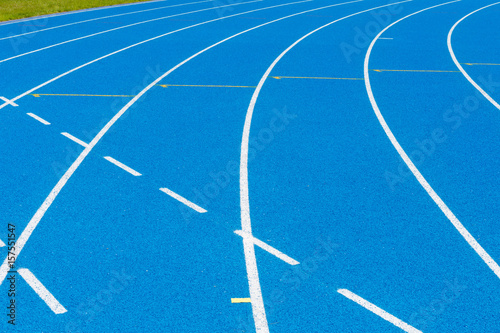 Blue Running track .Lanes of blue running track.Running track with blue asphalt and white markings in outdoor stadium.selective focus.