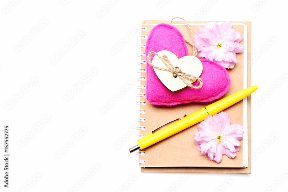 Notebook and pink felt heart with light sakura flowers