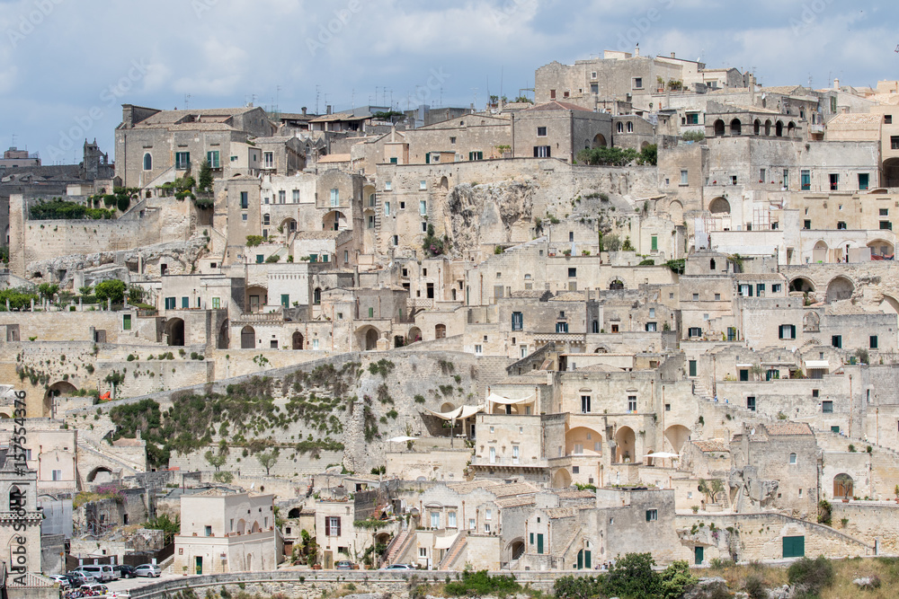 Matera, Italy - May 20, 2017: Panoramic view of the city from the belvedere square with background the clouds in the sky