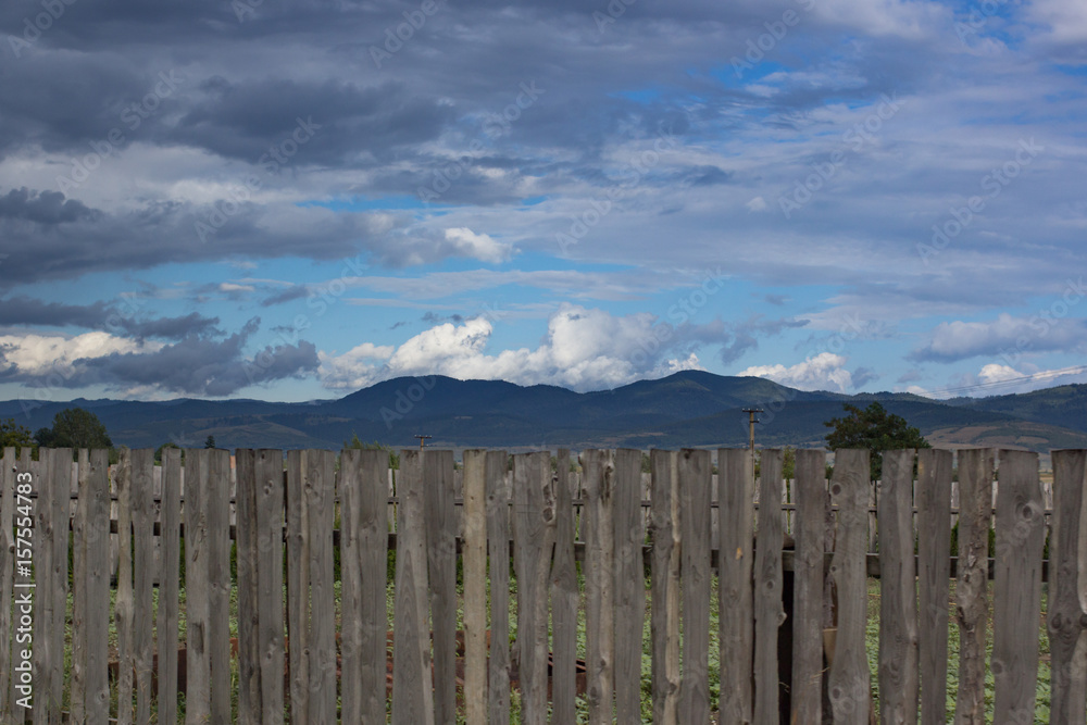 beautiful mountain landscape behind the wooden fence