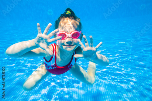 little girl  swimming  in pool